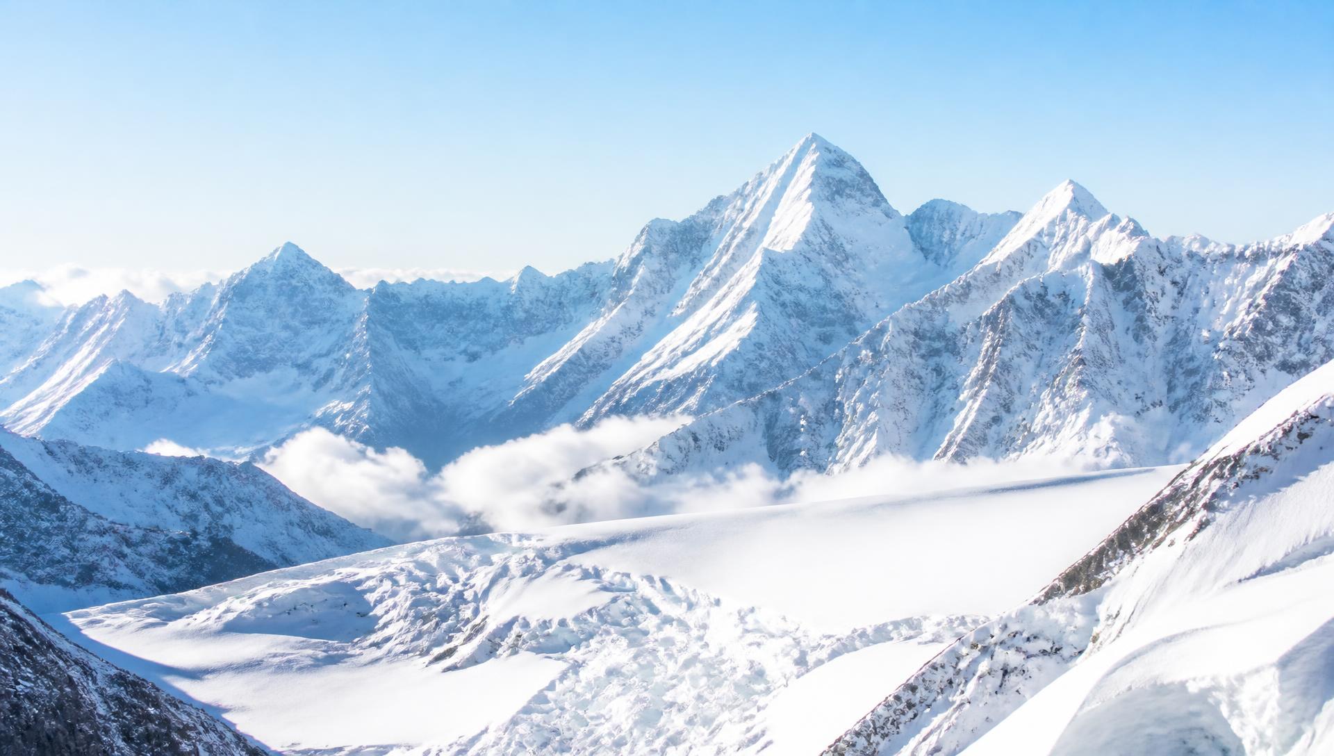 Bright snow-covered Himalayan peaks under a clear blue sky